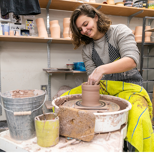 student at pottery wheel