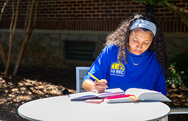 student studying on the plaza