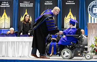 president congratulating a graduate
