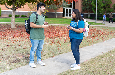students with fall leaves