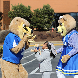 child with Mr and Mrs Bearcat
