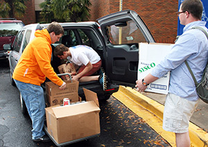 students loading canned goods