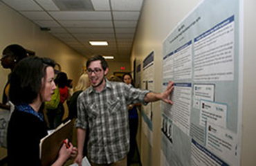 honors college student presenting poster