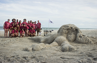 lander students with sand sculpture