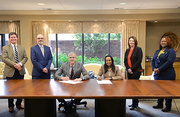 officials signing articulation agreement