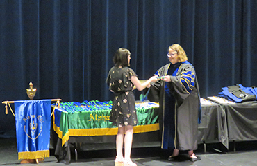 student receiving award at ceremony