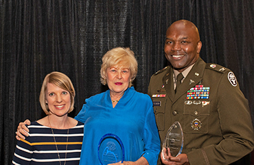Katie Troutman,  Sharon M. Adams, and  Col. Cory J. Plowden 
