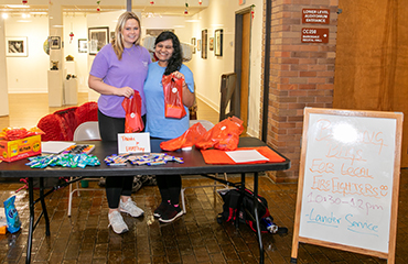 students at blessing bag table
