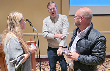 Andrew Jameson speaks to people at lecture