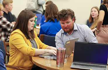 MaryKate Leggieri assisting students with assignments over breakfast