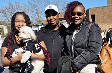 student with family at homecoming