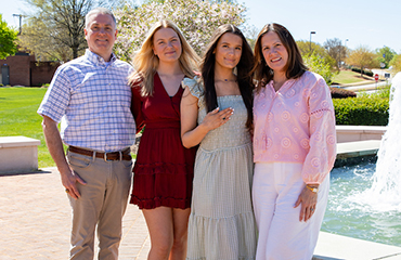 student at ring ceremony with family