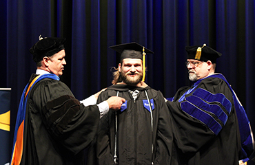 graduate at hooding ceremony