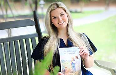 Emalie White with her book