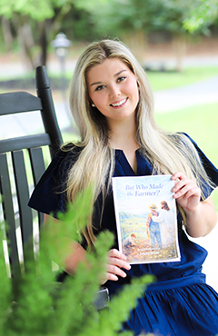 Emalie White with her book
